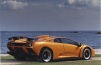 Lamborghini Diablo GT colore arancione sfondo mare trequarti posteriore in Sardegna